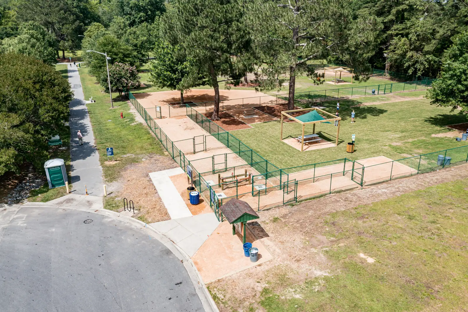 Dogs play inside a fenced off-leash dog park in Greenville, N.C.