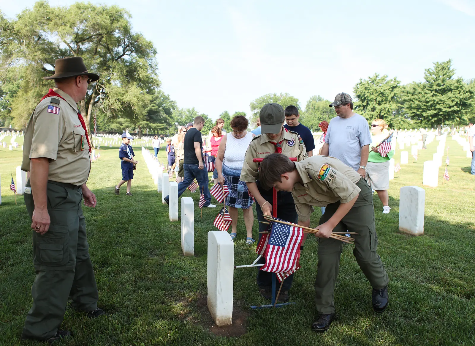 Boy Scouts place U.S. flags at graves in Nashville National Cemetery for Memorial Day.
