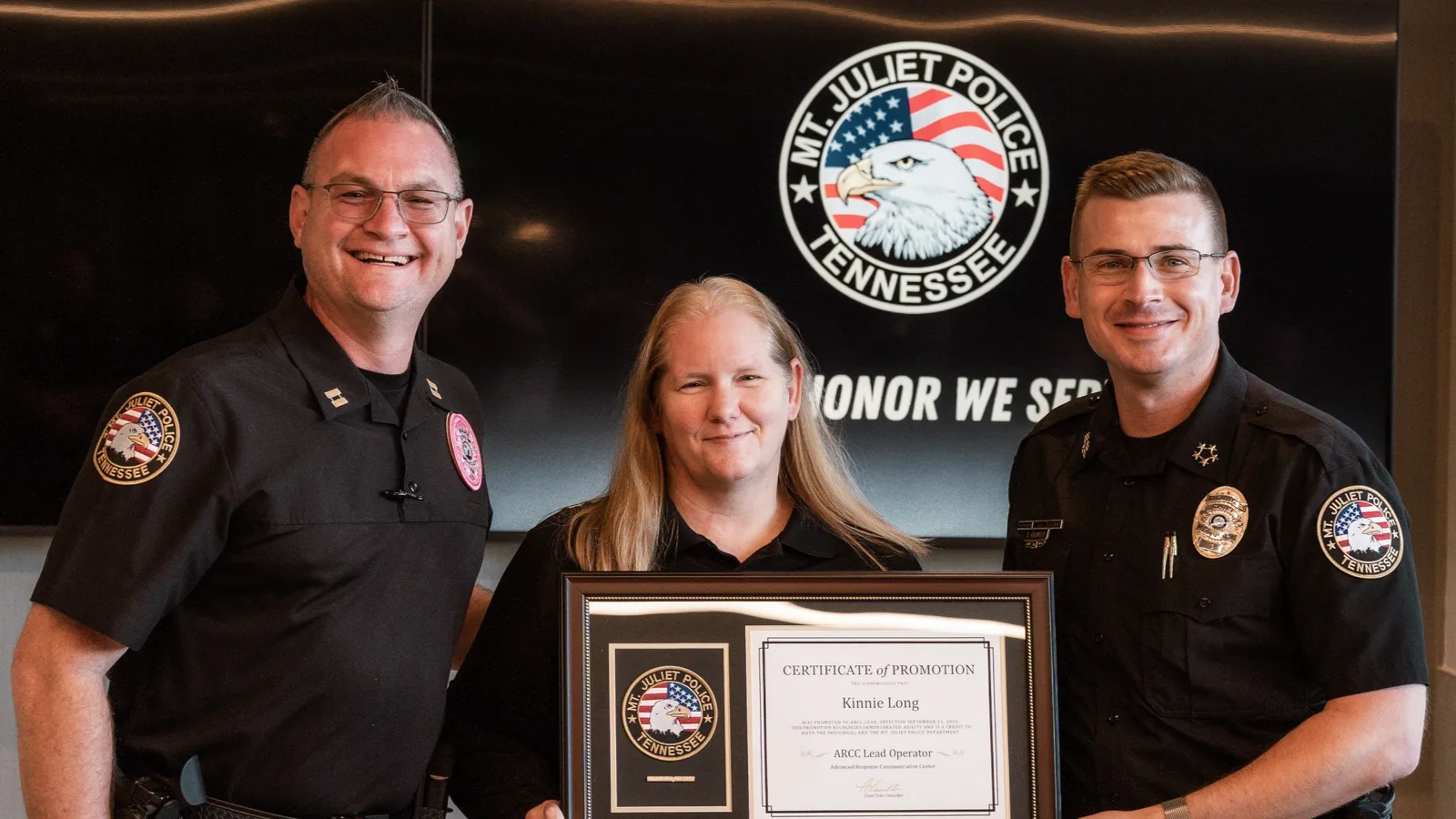 Capt. Jason Brockman, Kinnie Long and Chief Tyler Chandler with Long's certificate of promotion at the Mt. Juliet Police Department.