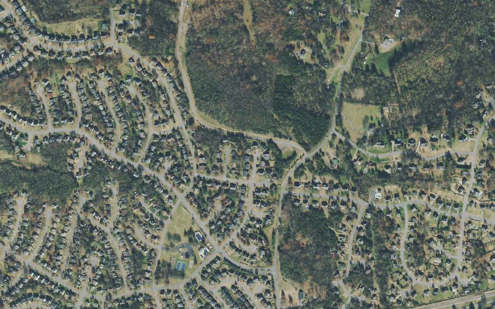 Aerial view of subdivisions and woods off South Greenhill Road in the Greenhill area of Mount Juliet, with the railroad along the bottom edge.