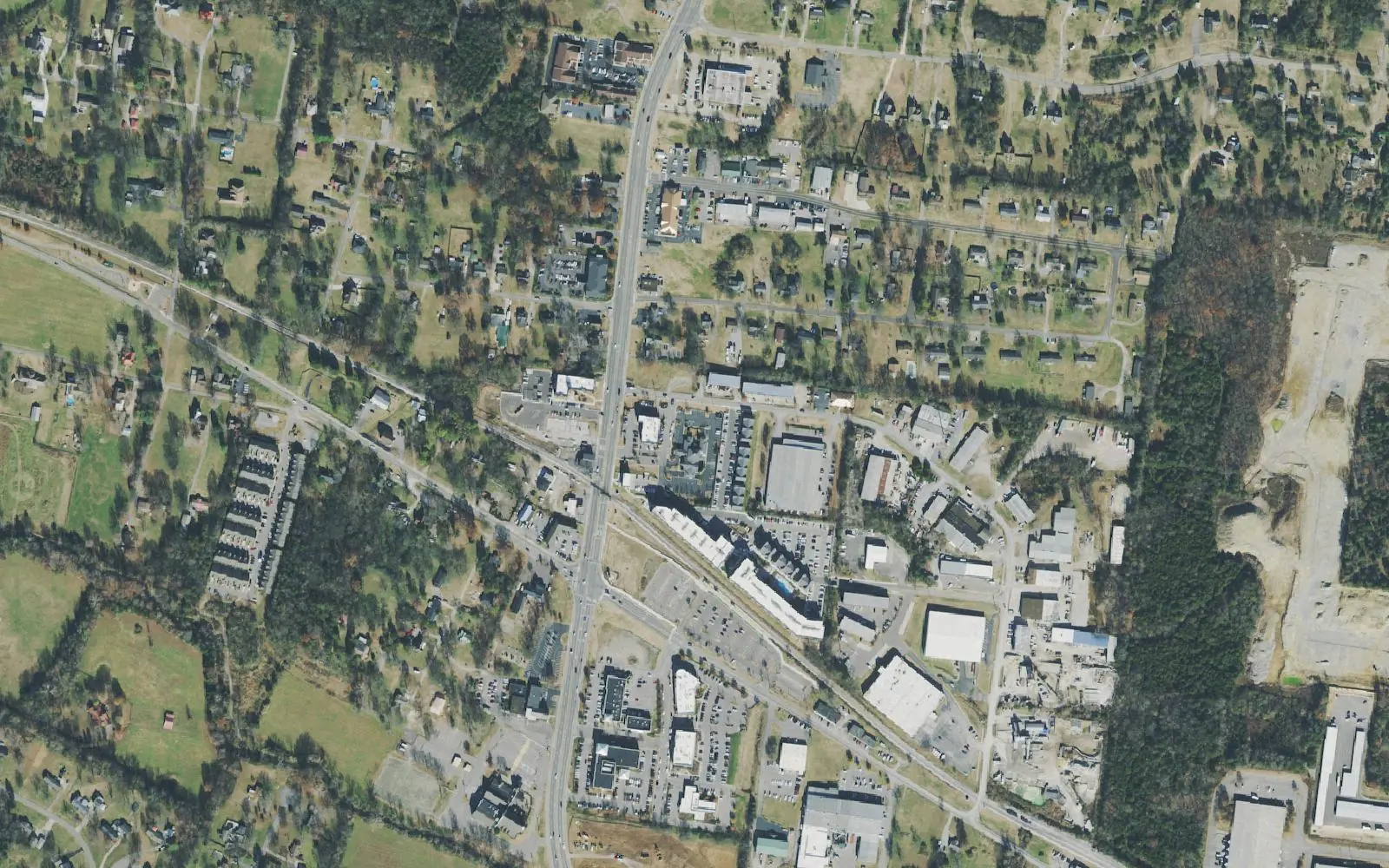 Aerial view of Mount Juliet's Town Center, where North Mt. Juliet Road crosses the railroad and Division Street, with the Mt. Juliet Station parking lot along the tracks.