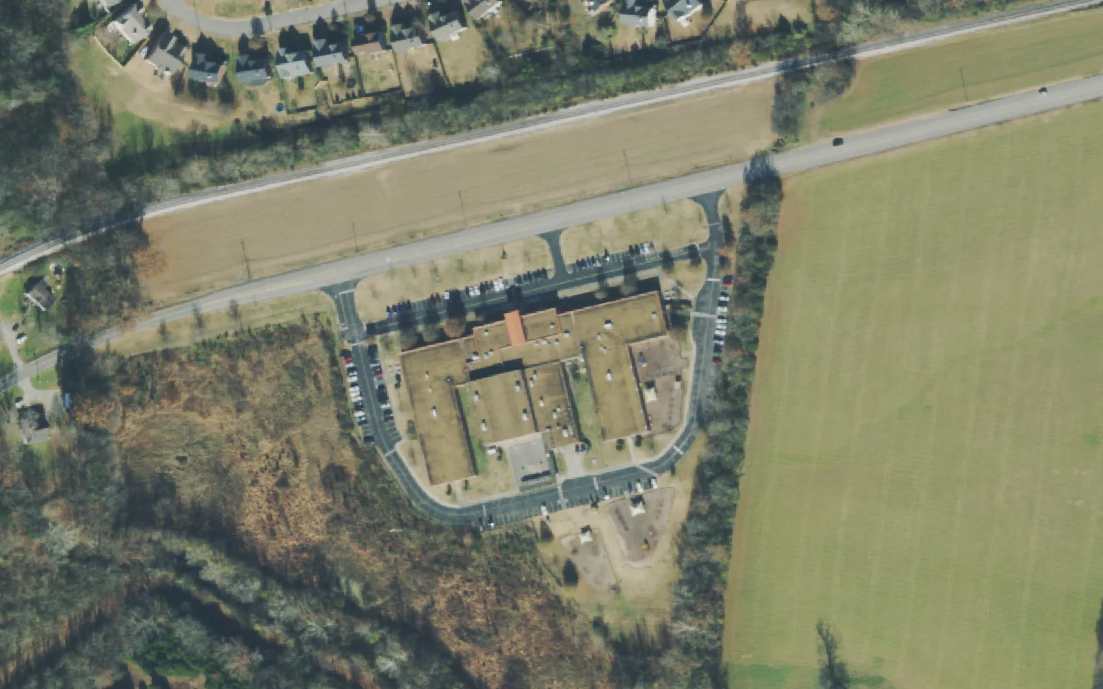 Mt. Juliet Elementary School's building and parking loop beside West Division Street, seen from the air.
