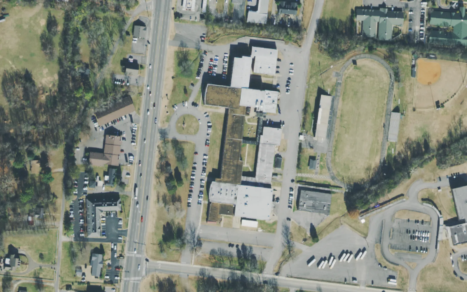 Mt. Juliet Middle School's buildings, track and ball fields beside North Mt. Juliet Road, seen from the air.