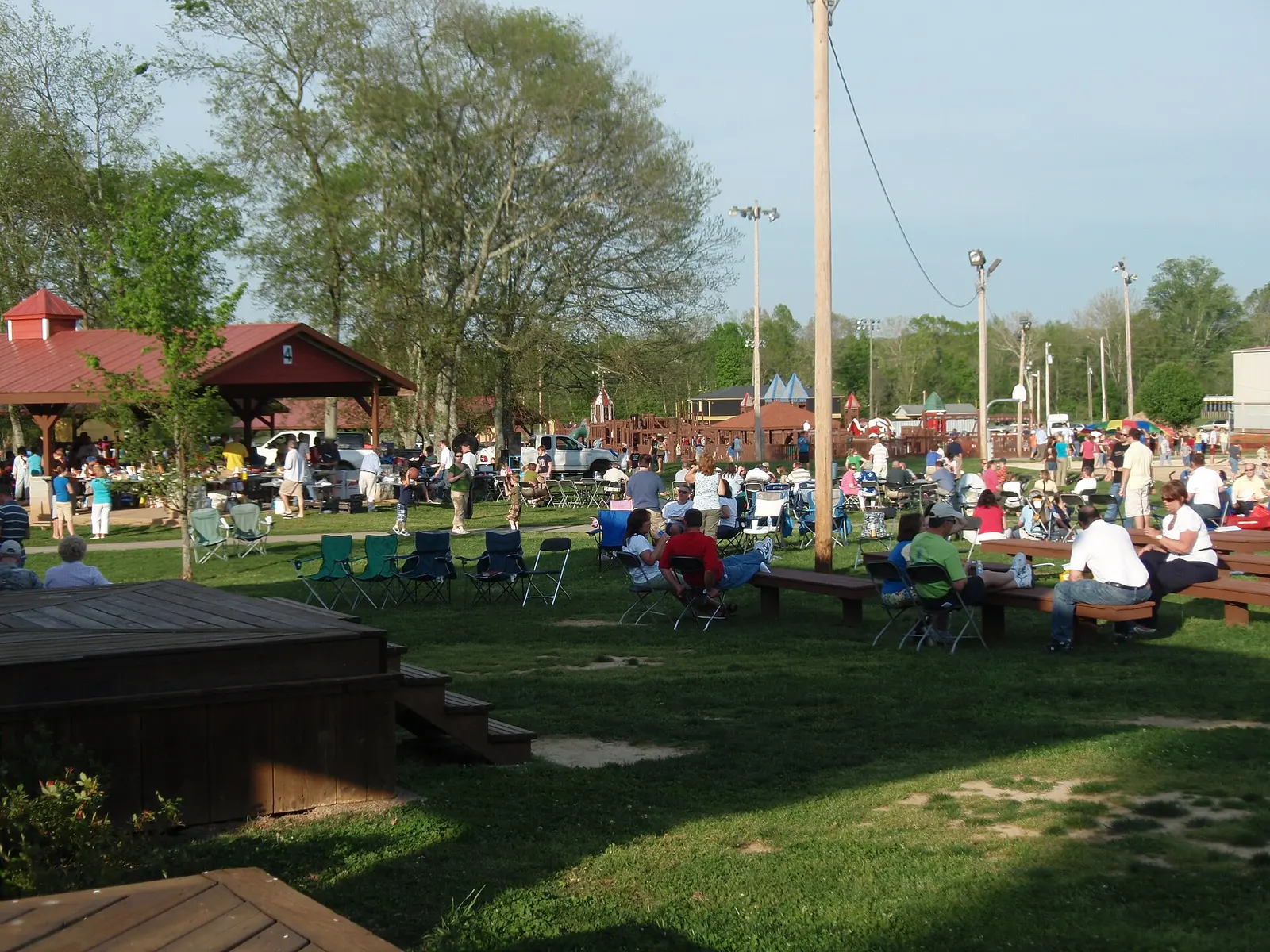 Families spread out on the lawn with picnic tables and lawn chairs during an event at Charlie Daniels Park in Mount Juliet.